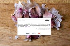 Screenshot of a food-blog search box over a photo of purple garlic cloves on wood