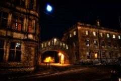 Hertford Bridge (Bridge of Sighs) spanning a dark Oxford street at night under a bright lamp